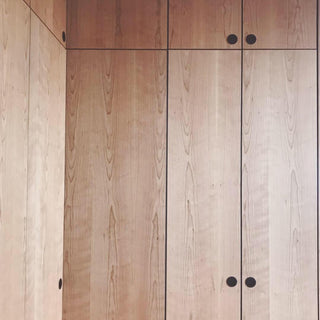Wooden wardrobe with four doors and black handles.