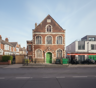 Brick building with a green door on a street corner